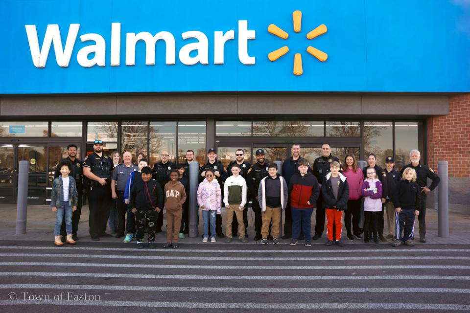 Members of Easton Police Department, Oxford Police Department, and Talbot County Sheriff's Office stand alongside their 'Shop with a Cop' companions at Walmart on Elliot Rd. in Easton.